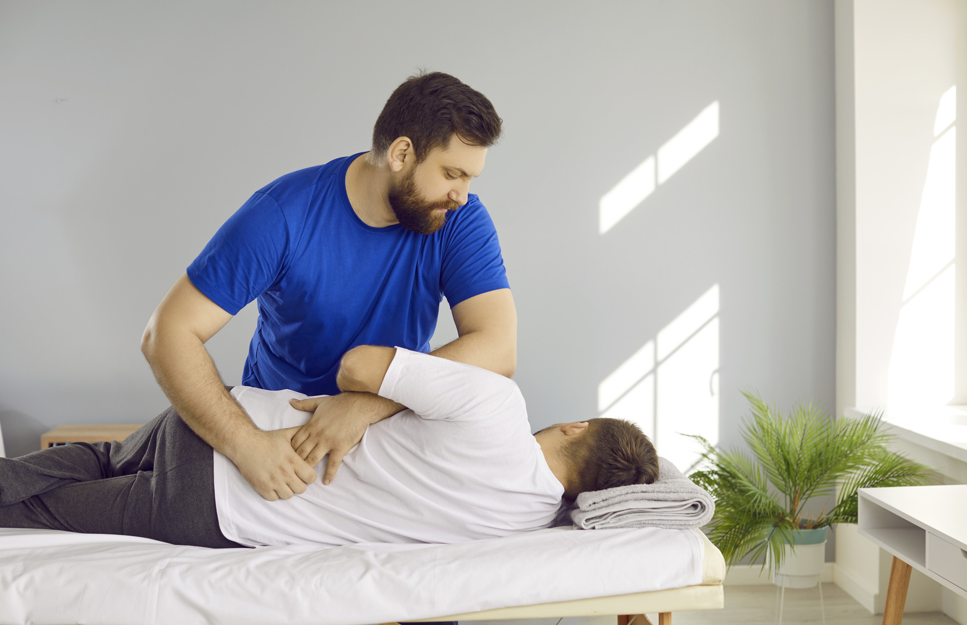 Chiropractor performing a spinal adjustment on a patient, symbolizing chiropractic care supported by accurate chiropractic billing services