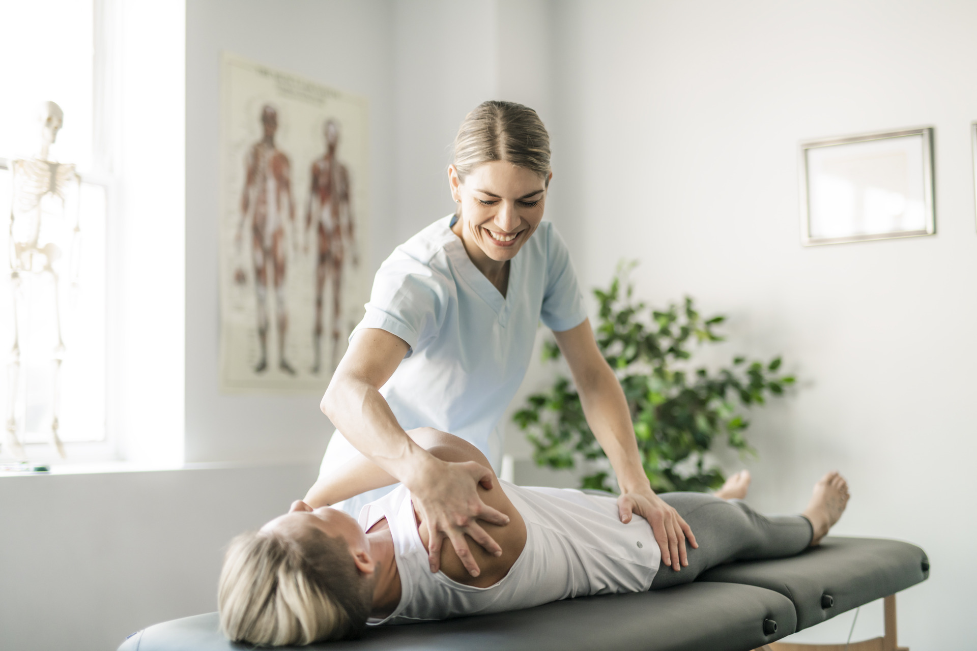 Female chiropractor performing a spinal adjustment on a patient, representing quality chiropractic care supported by accurate chiropractic billing services.