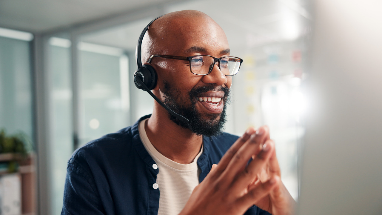 Chiropractic billing specialist providing customer support through a headset, representing personalized service from a chiropractic billing company.
