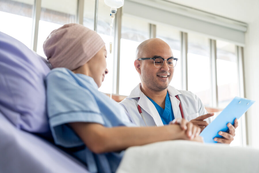 Oncologist reviewing treatment plan with cancer patient during chemotherapy visit