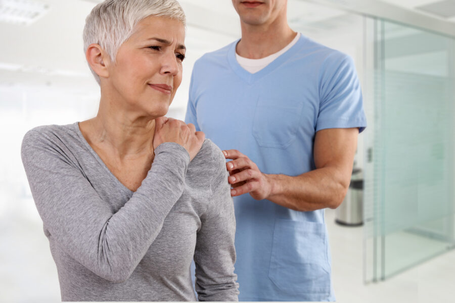 Patient receiving a physical examination for shoulder pain from a healthcare provider, representing common evaluations in pain management practices.